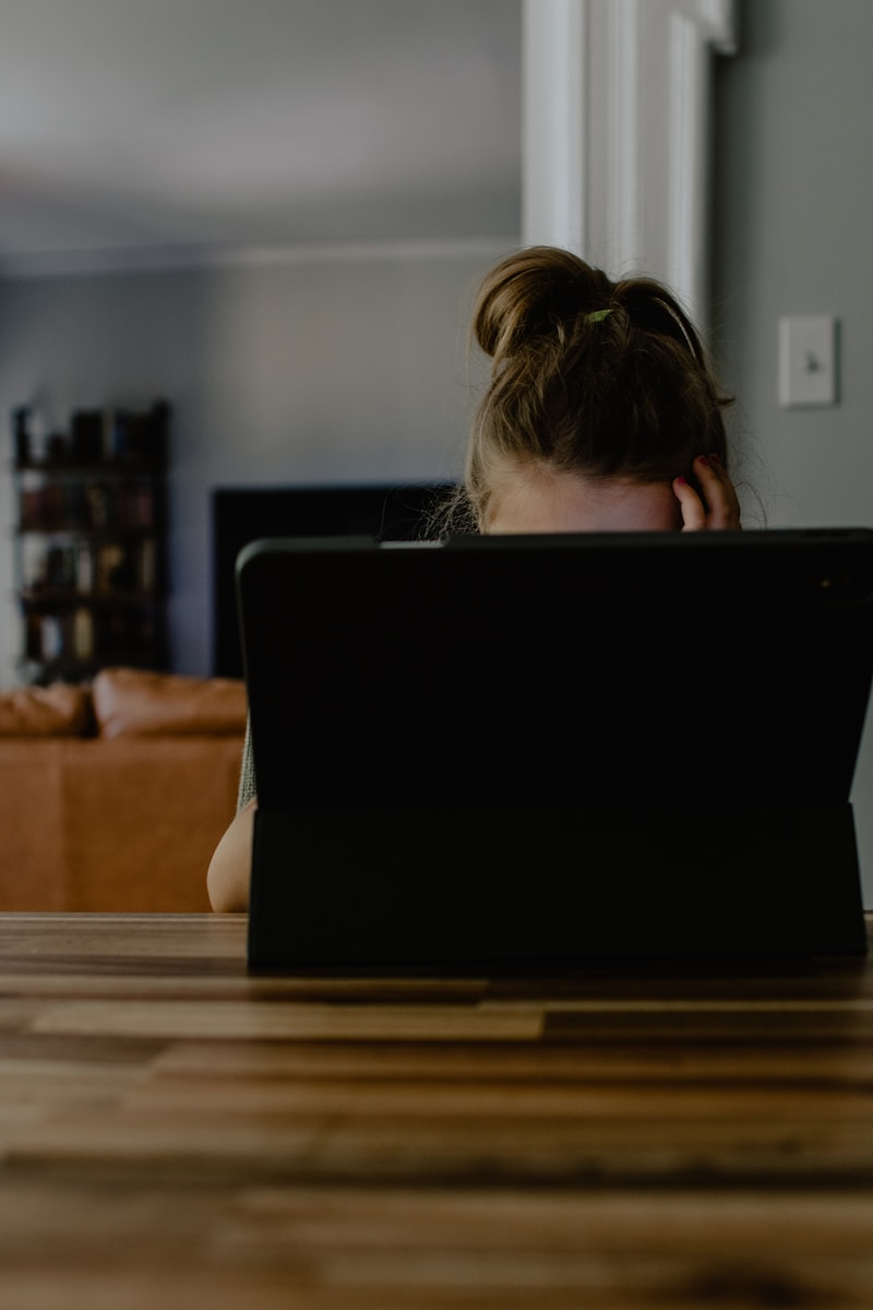 woman sitting and using black laptop computer